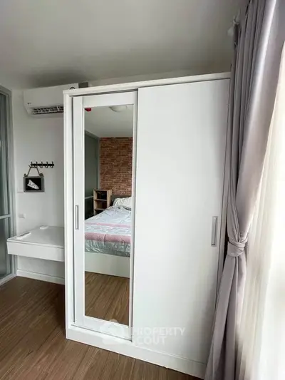 Modern bedroom with sliding wardrobe and natural light