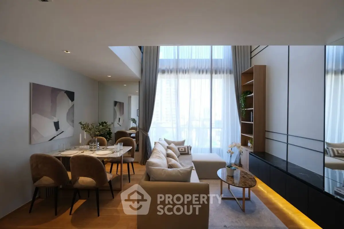 Luxurious modern living room with elegant decor and large windows offering city views.