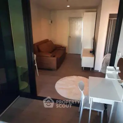 Modern living room with cozy brown sofa and sleek white furniture