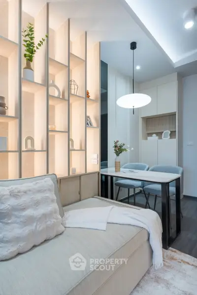 Modern living room with stylish shelving and cozy seating area, perfect for relaxation and entertaining.