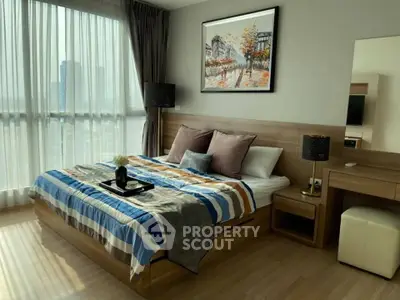 Modern bedroom with large window and stylish decor in a high-rise apartment.
