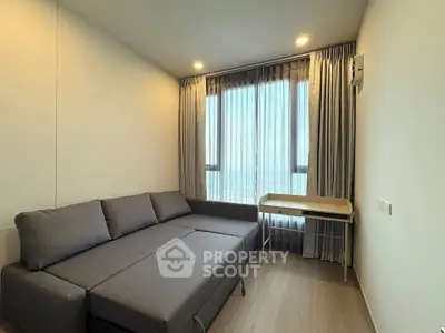 Modern living room with gray sofa and large window with curtains