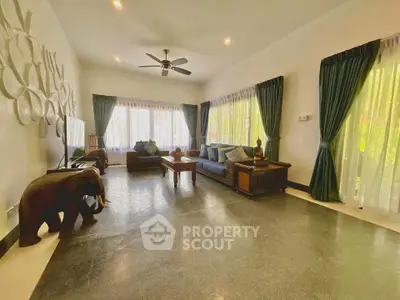 Spacious living room with elegant decor and large windows for natural light.