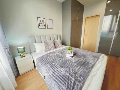 Modern bedroom with stylish decor and cozy ambiance, featuring a plush bed and elegant furnishings.