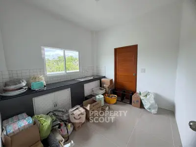 Spacious storage room with boxes and natural light, ideal for organizing household items.
