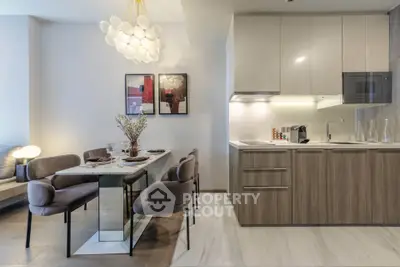 Modern kitchen and dining area with elegant lighting and sleek cabinetry