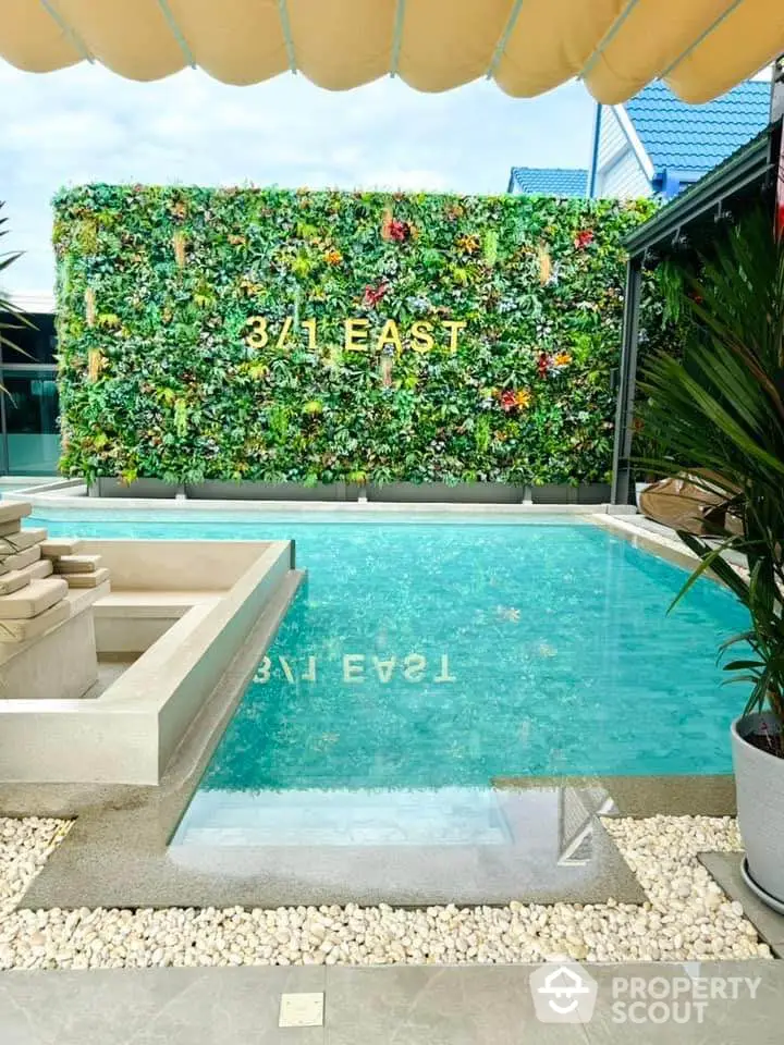 Luxurious pool area with vertical garden at 341 East, perfect for relaxation and entertainment.