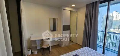 Modern bedroom with balcony view in urban high-rise apartment