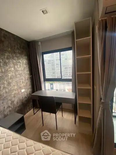 Modern bedroom with study area and large window offering city view