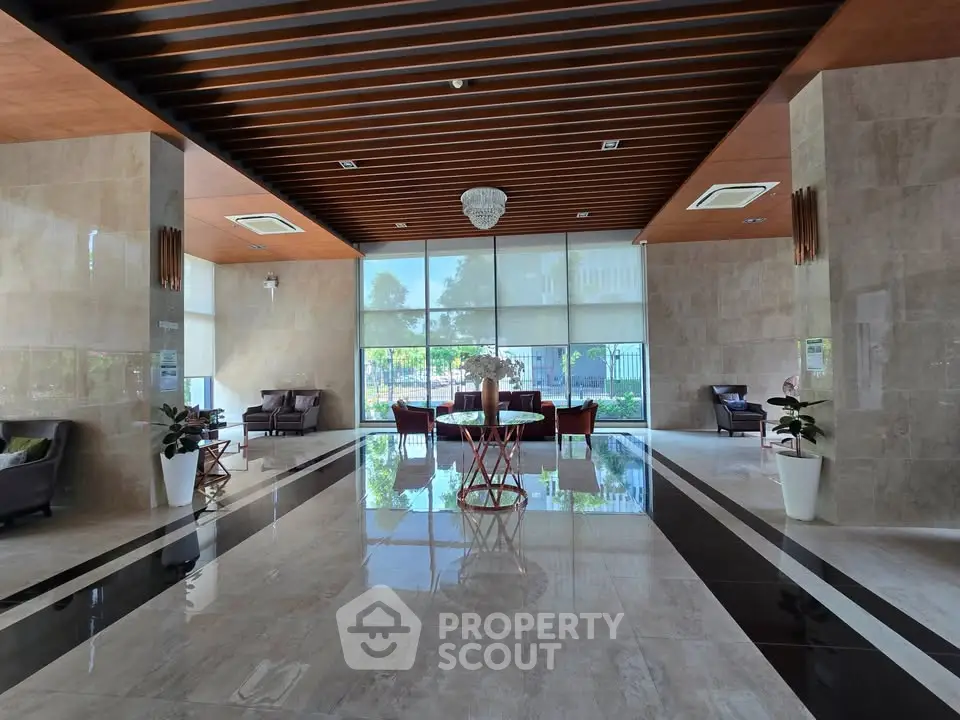 Luxurious building entrance with elegant decor and modern seating area.