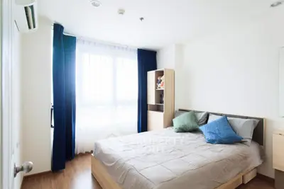 Bright and airy bedroom with large windows, wooden flooring, and a cozy double bed, perfect for a restful retreat in a modern home.