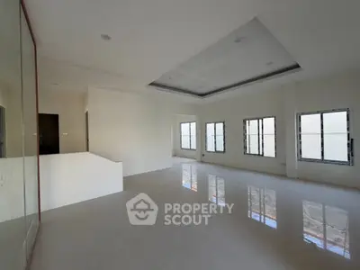 Spacious modern living room with large windows and sleek flooring