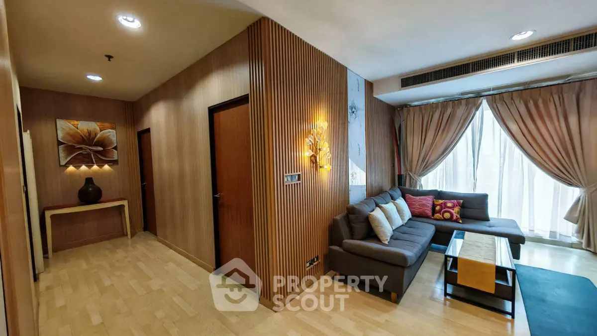Stylish living room with modern decor and cozy seating area, featuring elegant curtains and warm lighting.