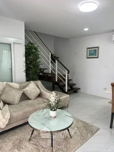 Modern living room with stylish staircase and cozy seating area