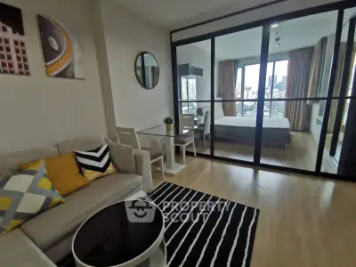 Modern open-plan living room with stylish decor and city view bedroom