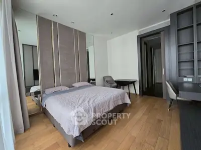 Spacious modern bedroom with elegant decor and wooden flooring