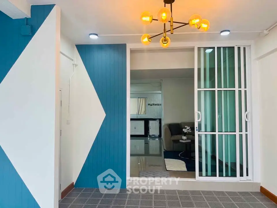 Modern interior with stylish lighting and sliding glass doors in a contemporary living space.