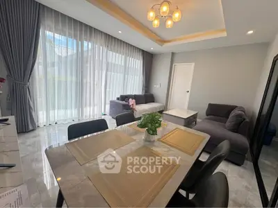 Modern living room with elegant dining area and large windows