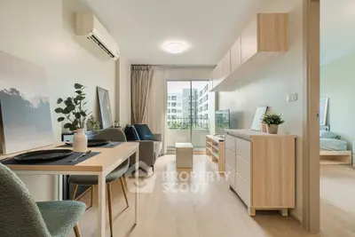 Modern living room with open layout and stylish decor, featuring a dining area and balcony view.