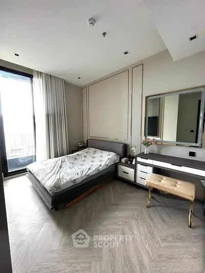 Luxurious bedroom with elegant decor and large window offering natural light.
