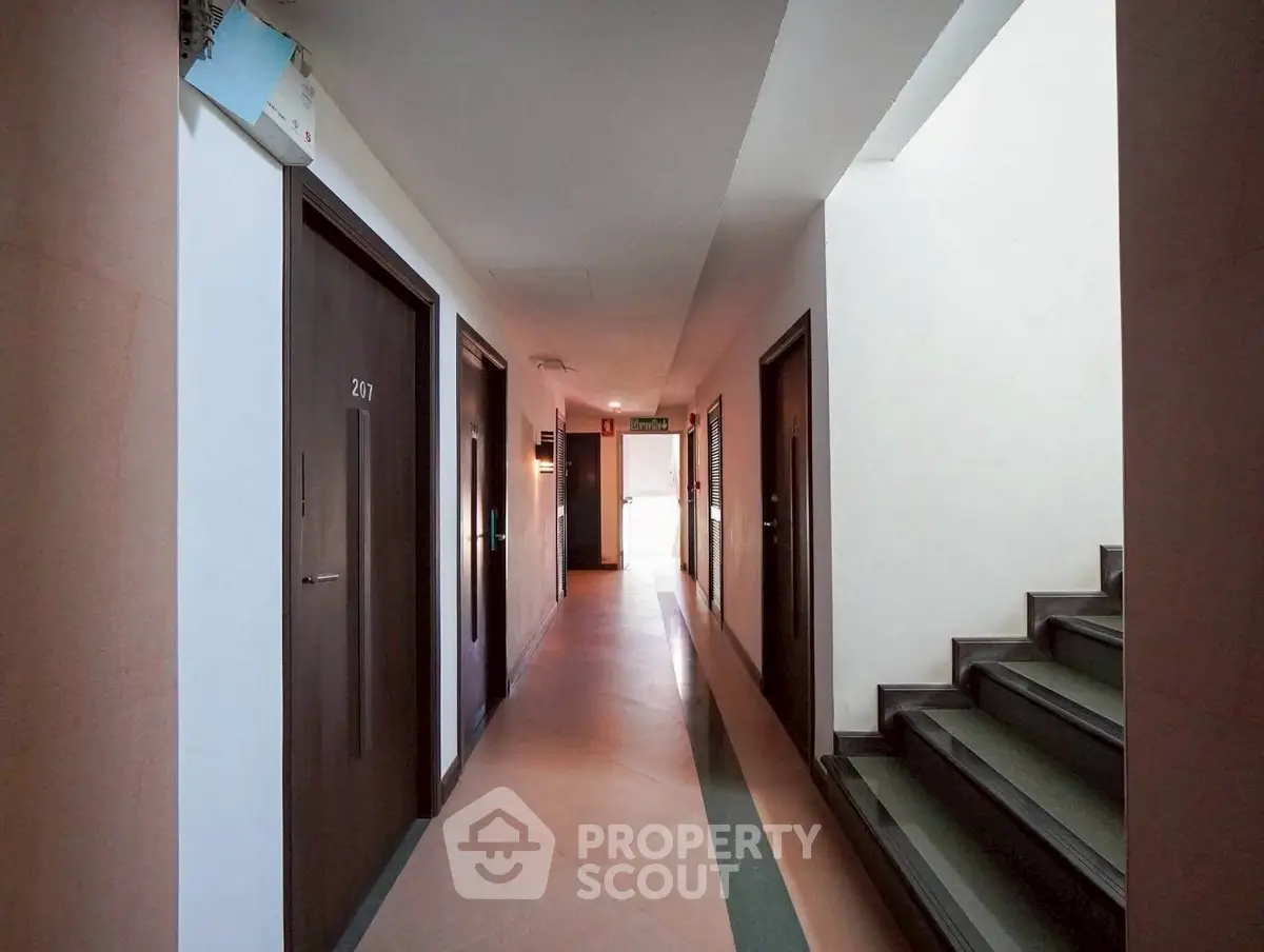 Modern apartment corridor with sleek design and natural lighting