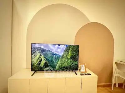 Modern living room with stylish TV setup and elegant arch design