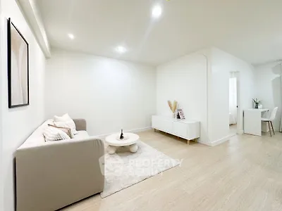 Spacious modern living room with minimalist decor and cozy seating area.