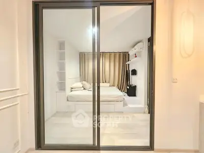 Modern bedroom with sliding glass doors and cozy decor
