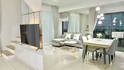 Modern open-plan living and dining area with elegant decor and natural light.