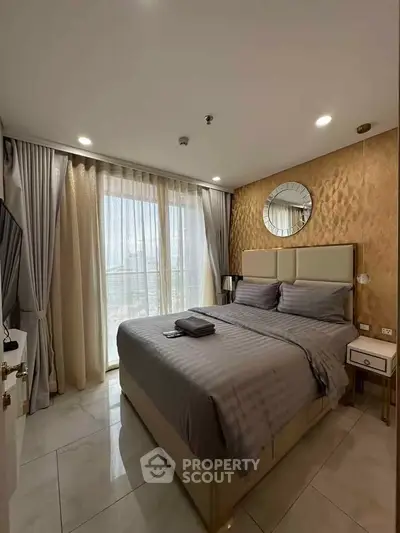 Luxurious bedroom with elegant decor and large window offering natural light.