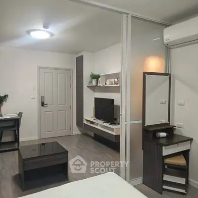 Modern studio apartment with sleek furniture and air conditioning