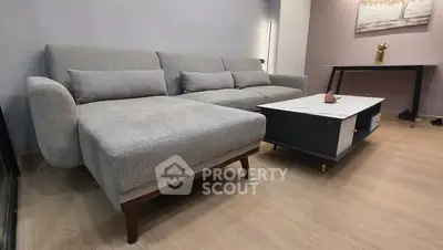 Modern living room with stylish gray sofa and sleek coffee table