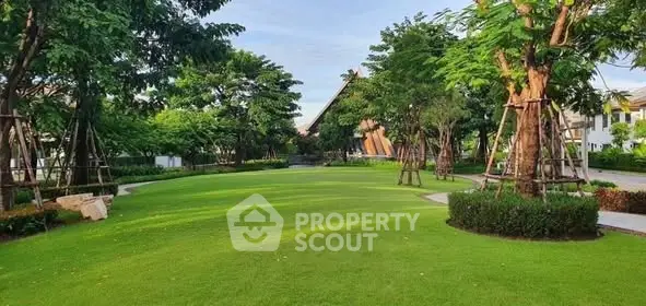 Lush green garden with manicured lawns and mature trees in a serene residential area.