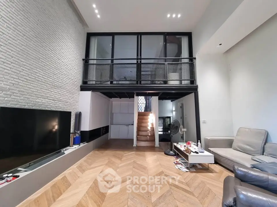 Modern loft-style living room with mezzanine and sleek design