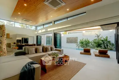 Luxurious open-plan living room with pool view and modern decor