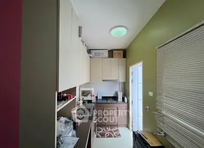 Modern kitchen with sleek cabinetry and gas stove in compact layout
