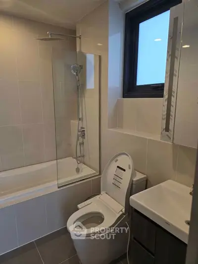 Modern bathroom with sleek fixtures and bathtub in contemporary apartment.