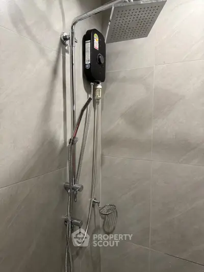 Modern bathroom with sleek shower fixtures and tiled walls.