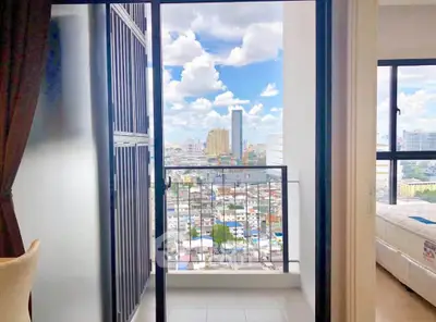 Stunning city view from modern apartment balcony with clear skies.