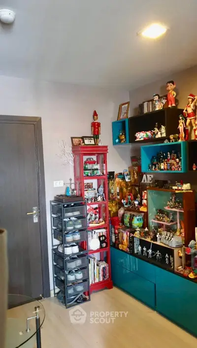 Charming living room with colorful shelves and collectibles, perfect for displaying personal treasures.
