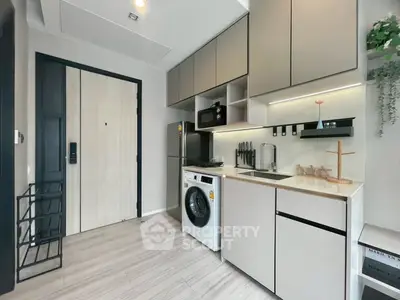 Modern compact kitchen with integrated appliances and sleek cabinetry