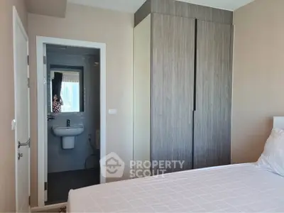 Modern bedroom with ensuite bathroom and sleek wardrobe design