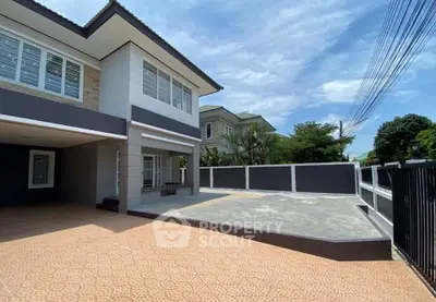 Modern two-story house with spacious driveway and contemporary design