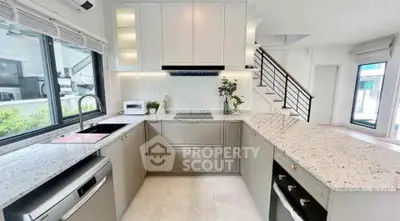 Modern kitchen with sleek countertops and built-in appliances in a bright, airy space.