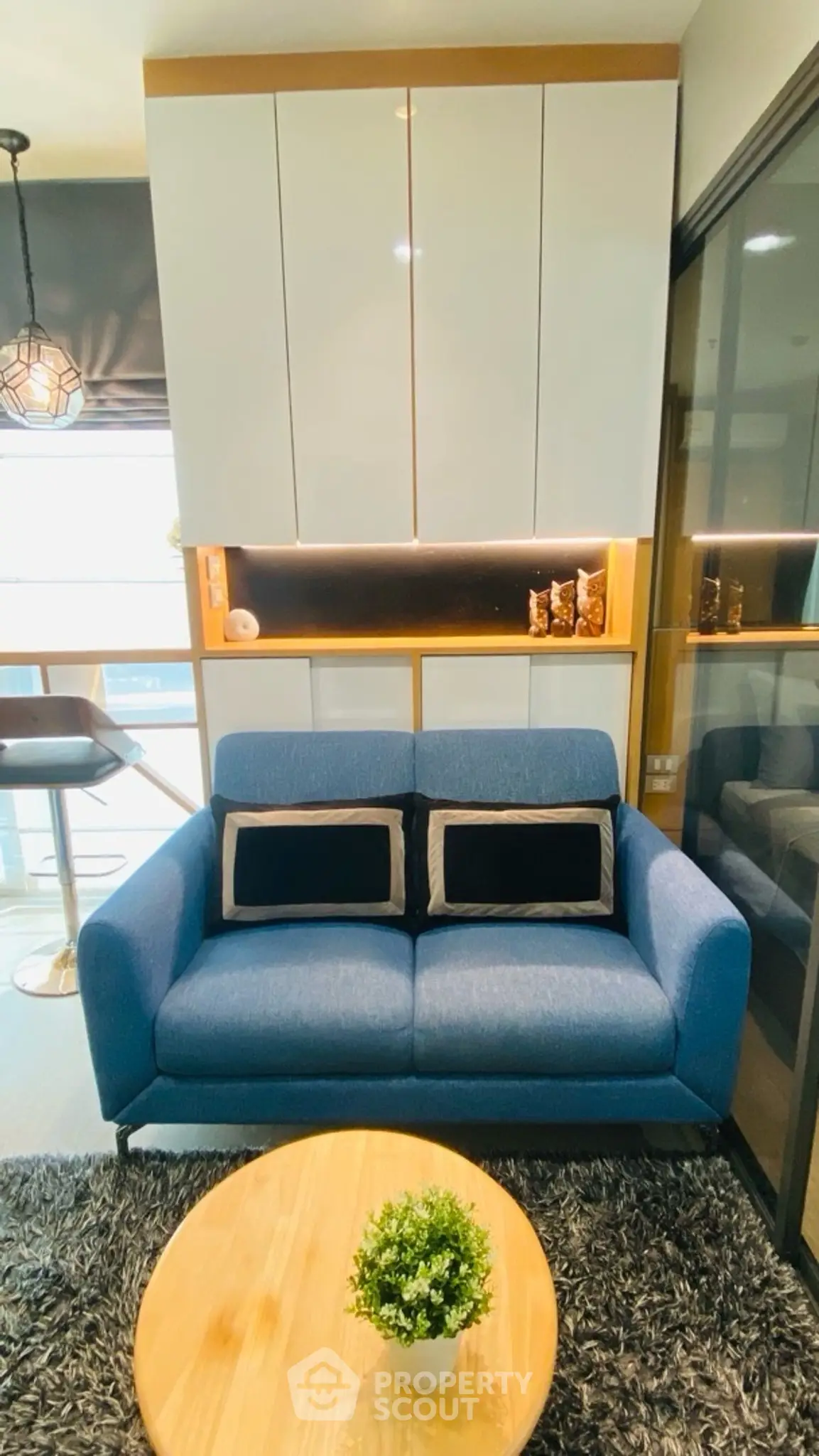 Stylish modern living room with blue sofa and chic decor