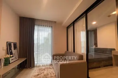 Modern living room with cozy sofa and large window in stylish apartment
