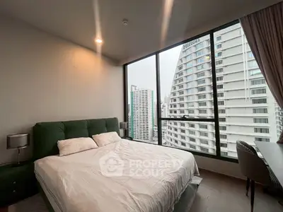 Modern bedroom with large windows offering stunning city views in a high-rise apartment.