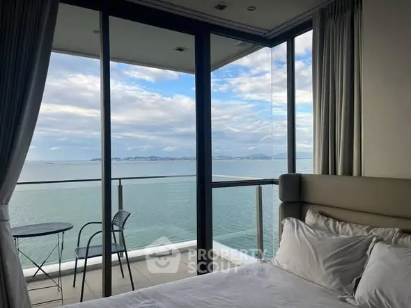 Luxurious bedroom with stunning ocean view and spacious balcony.
