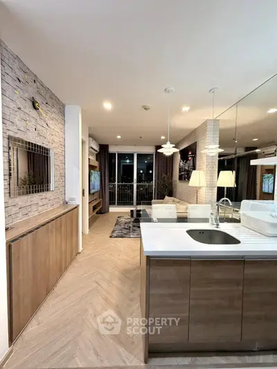 Modern open-layout kitchen and living room with stylish decor and balcony view.