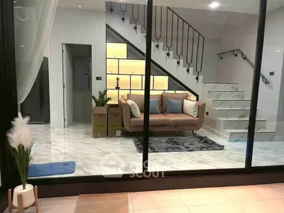 Modern interior with stylish staircase and cozy seating area